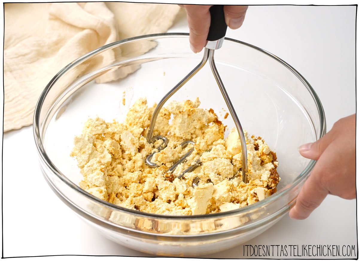 Add the tofu and use a potato masher to smash it into crumbles.