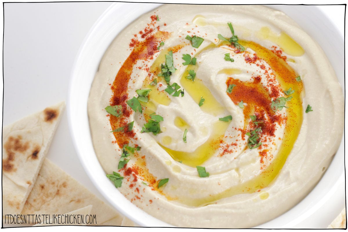 After years of recipe testing, I'm finally sharing with you my recipe for the Best Easy Hummus! This hummus recipe is extra creamy, super delicious, oil-free, requires no peeling, and so much better than store-bought. (It's quick and easy to make too)! Learn the secret tricks and tips to make the best homemade hummus ever! #itdoesnttastelikechicken #hummus #appetizer #dip 