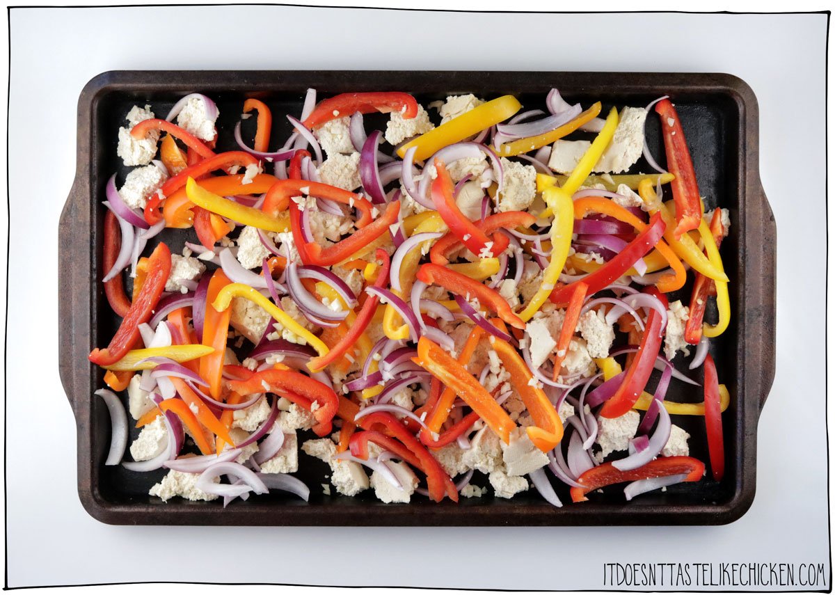 Slice the veggies and tear the tofu into bite-sized pieces and spread across a large baking sheet.