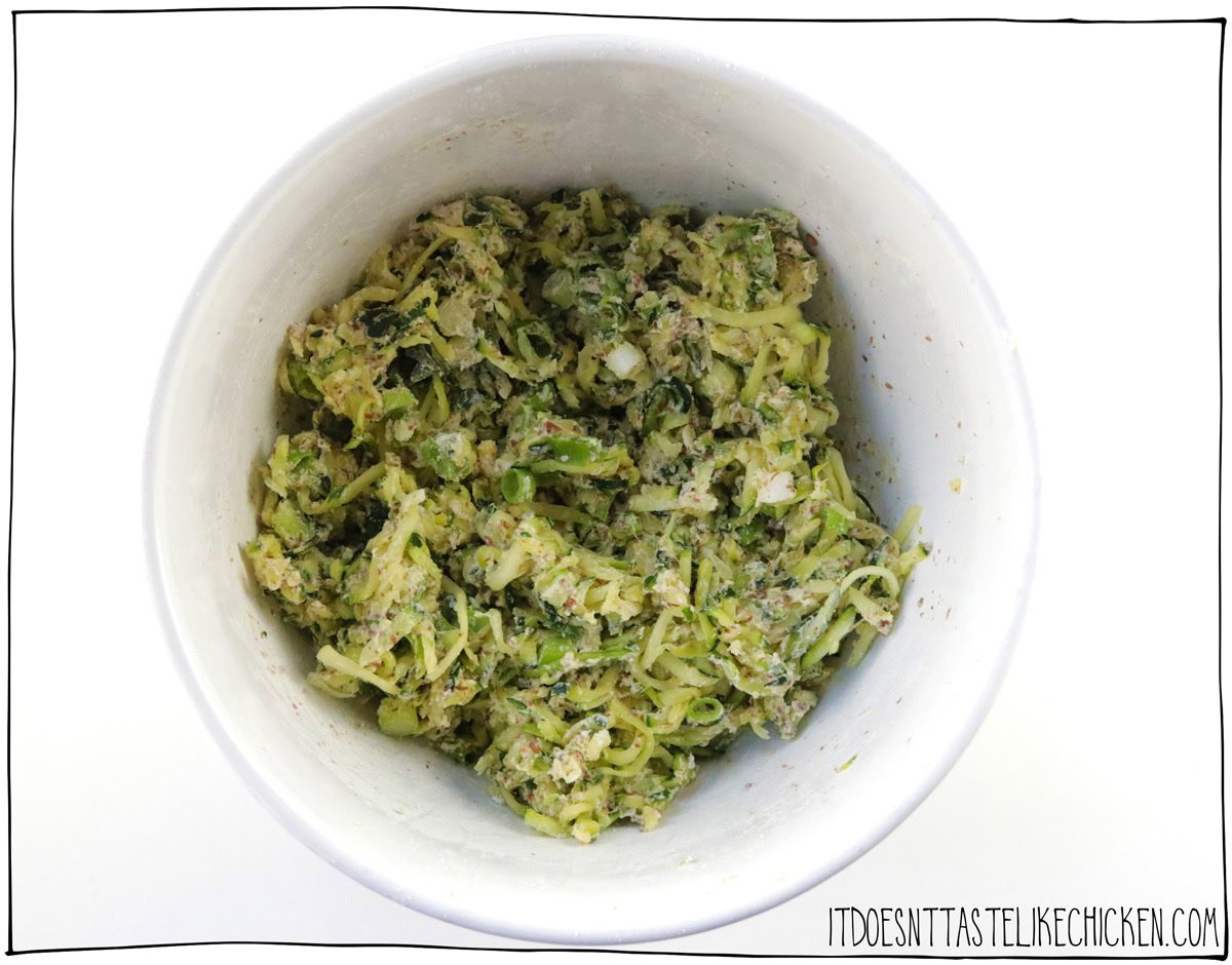 In a large bowl, whisk together the flour, baking powder, garlic powder, ¼ teaspoon salt, and black pepper. Add the squeezed zucchini, thickened flax or chia mixture, and green onions, and mix well. The mixture will be quite sticky, and you may need to use your hands to mix.