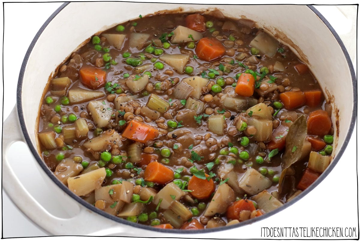 This Hearty Vegan Lentil Stew is full of warming stick-to-your-ribs flavors that are perfect for a chilly night. Packed with carrots, celery, potatoes, peas, and lentils this rich stew is full of good-for-you veggies, that are simmered in a hearty gravy sauce made with red wine. YUM. #itdoesnttastelikechicken #stew #veganrecipes