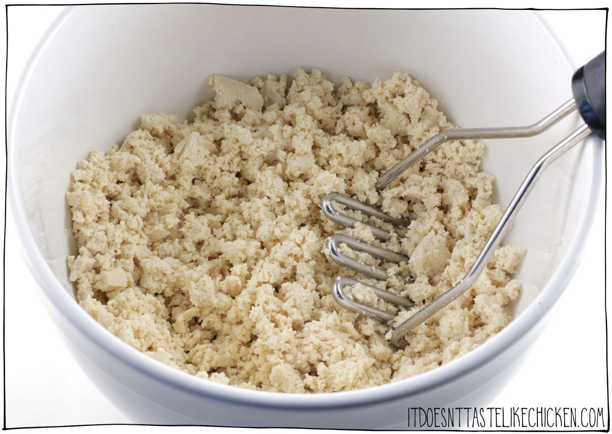 Mash the tofu with a potato masher to crumble it.