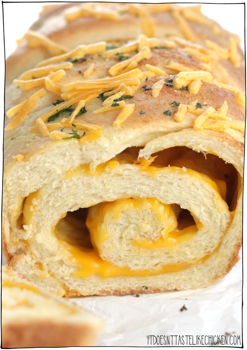 Indulge in the ultimate comfort food with this Vegan Cheese Bread recipe. This homemade cheesy bread is soft and fluffy and infused with the irresistible flavors and aromas of garlic, vegan butter, and swirls of gooey vegan cheese. Perfect for snacking or serving as a side dish with your favorite soup.