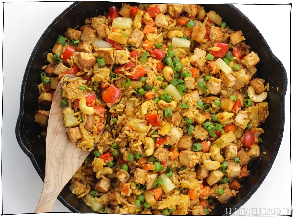 Stir in the cooked tofu, rice, pineapple, peas, soy sauce, and Sriracha (if using), heating through. If the rice seems dry, add a splash of reserved pineapple juice as needed. Serve hot, garnished with the dark green parts of the green onions. 