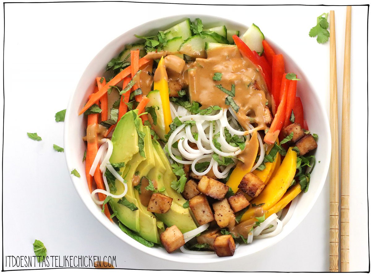 This recipe tastes just like the Vietnamese cold spring rolls, but disassembled in a bowl! Skip the fiddly wrappers and make a Vegan Spring Roll in a Bowl instead! This fresh, healthy, flavor-packed bowl is a complete meal and can be whipped up in just 30 minutes.  Seasoned tofu cubes, hot or cold rice noodles, fresh veg with mango and avocado, a ton of fresh herbs (this is the key to irresistible flavor), all drizzled in delicious peanut sauce.